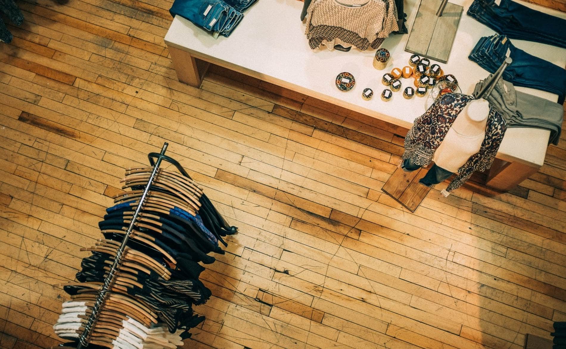 an overhead view of a clothing store with clothes on racks