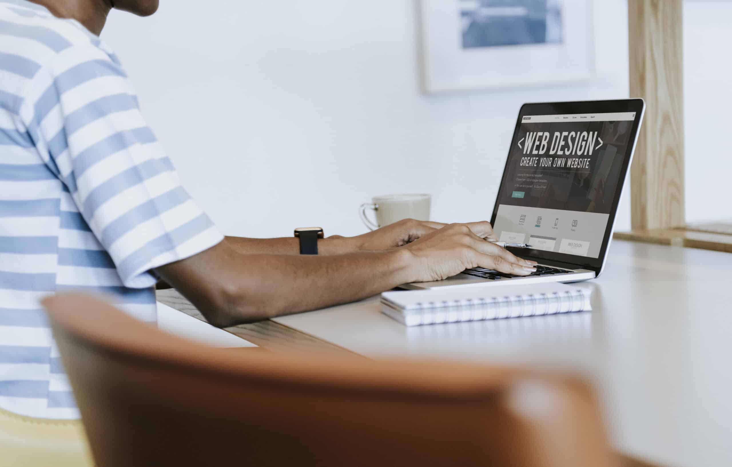 Black lady working on a laptop in her office